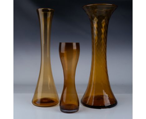 Trio of amber glass vases featuring fluid, sculptural forms that embody the essence of Mid-Century Modern design. The last on