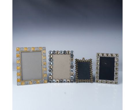 This set of four decorative picture frames features a blend of glass and crystal embellishments. Two frames display sparkling