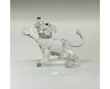 This Swarovski crystal lion cub was part of the African Wildlife collection. It is made from clear crystal with a black nose 