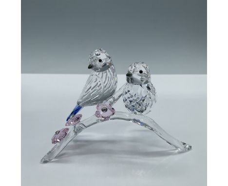 Beautiful couple of facetted birds perched on a clear crystal branch adorned with three rosaline crystal flowers. Swarovski e