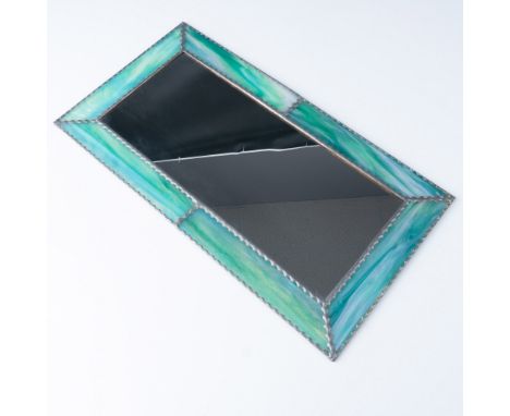 A rectangular stained glass framed mirror featuring vibrant green and iridescent accents. The frame showcases a handcrafted d