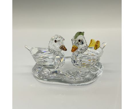 A set of three clear crystal figures, two ducks and a pond for them to be placed upon. Both ducks have clear bodies and brown