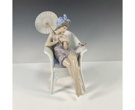 This delicate figure features a seated woman in a lavender polka dot bathing suit, holding a parasol, with a small bird perch