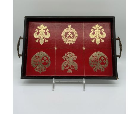 Elegant vintage Swedish serving tray featuring a regal red leather surface adorned with gold-embossed heraldic crests and fle