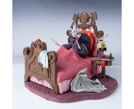 A porcelain figure of Cruella De Vil from 101 Dalmatians, in bed while talking on the phone. Part of the Villains series. WDC