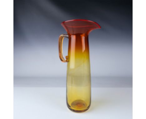 Blenko, Wayne Husted hand-blown glass pitcher, 586, from 1958.  It is crafted with a curved, clear handle and a wide, flared 