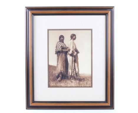 Featured in this lot we have a black and white framed photo by Edward S. Curtis titled "Piegan Girls" originating from the ea