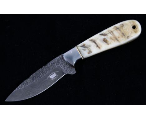 This is an original Montana Territory Knives of Bozeman, Montana knife showing a Rocky Mountain Rams Horn grip and forged Dam