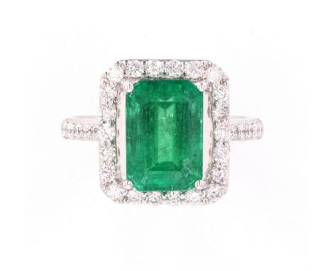 The lot features a GIA and AIG certified natural Emerald and Diamond ring set in platinum. At the center of the piece shows a