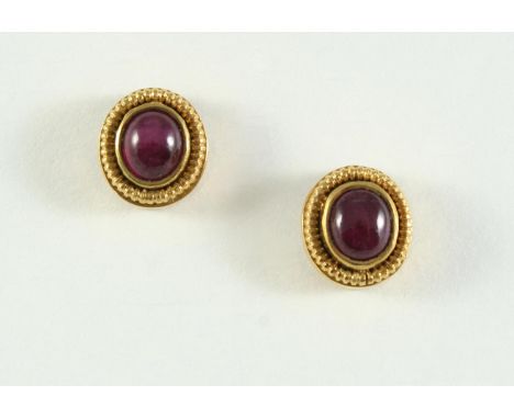 A PAIR OF GOLD AND RUBY STUD EARRINGS BY LALAOUNIS each set with an oval ruby cabochon within an 18ct gold ridged mount