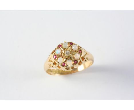AN OPAL, DIAMOND AND RUBY CLUSTER RING the circular-cut diamond is set within a surround of solid white opal cabochons and ci