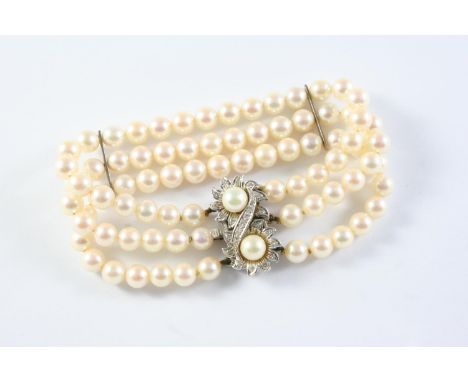 A THREE ROW UNIFORM CULTURED PEARL AND DIAMOND BRACELET the pearls measure approximately 6.2mm and are set to a double flower