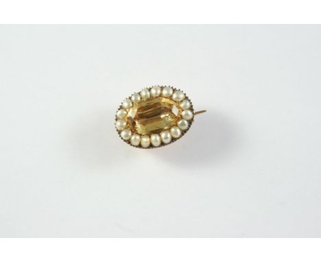 A GEORGIAN TOPAZ AND PEARL SET BROOCH the oval-shaped foil backed topaz is set within a surround of half pearls, in gold, 2.1