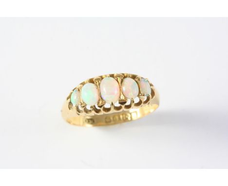 AN OPAL FIVE STONE RING the five graduated oval solid white opals are set in 18ct gold. Size L 1/2