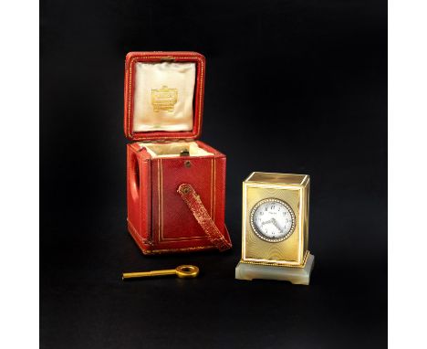 A GOLD, ENAMEL AND AGATE MINIATURE CARRIAGE CLOCK BY CARTIER the rectangular engine turned gold case with white enamel decora
