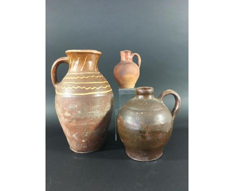 MEDIEVAL STYLE SLIPWARE PITCHER of baluster form with bands of yellow slip decoration, height 33cm; together with a treacle g