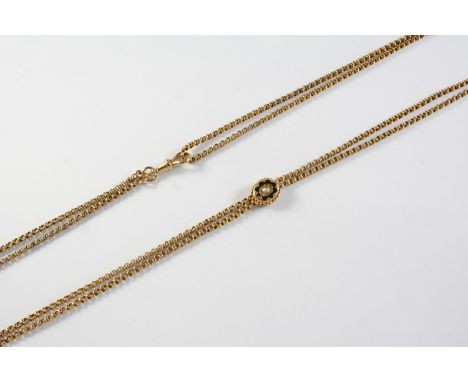 A VICTORIAN GOLD AND ENAMEL MUFF CHAIN formed with triple circular links, with a gold slide, mounted with a half pearl and bl