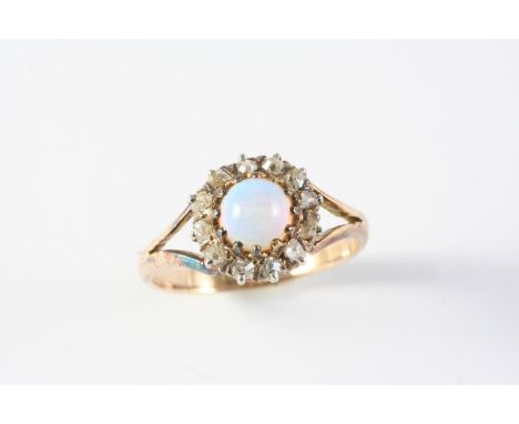 AN OPAL AND DIAMOND CLUSTER RING the circular solid white opal is set within a surround of rose-cut diamonds, in 18ct gold. S