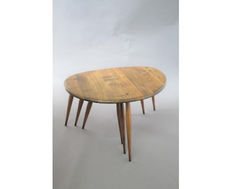 ERCOL NEST OF TABLES a set of 3 'Pebble' dark elm graduated occasional tables. Largest table 65cms across. (3)