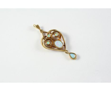 AN OPAL AND GOLD PENDANT the oval-shaped opal is set within a gold openwork surround set with three circular-cut opals and su