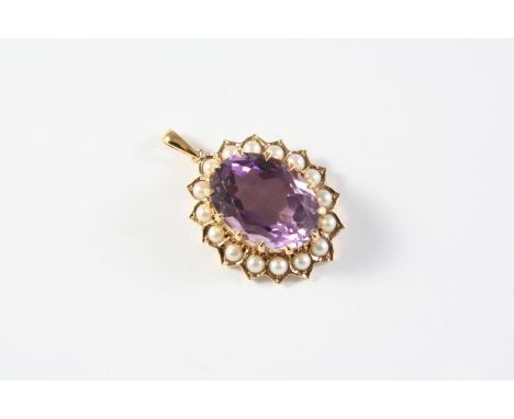 AN AMETHYST AND PEARL CLUSTER PENDANT the oval-shaped amethyst is set within a surround of half pearls in gold, 2.5cm long