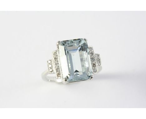 AN AQUAMARINE AND DIAMOND RING the step-cut aquamarine is set with two rows of circular-cut diamonds in platinum. Size M 1/2