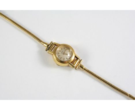 A LADY'S 18CT GOLD WRISTWATCH BY OMEGA the signed circular dial with baton numerals, the winder signed Omega, on an 18ct gold