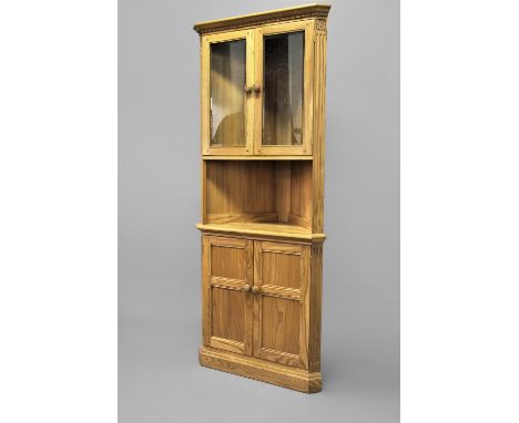 MODERN ERCOL CORNER CABINET a large light elm corner cabinet, with a glazed top section and carved rosettes to each side. Wit
