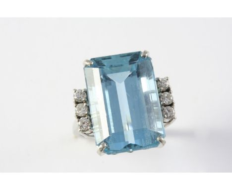 AN AQUAMARINE AND DIAMOND RING the step-cut aquamarine is set with three circular-cut diamonds to each shoulder, in white gol