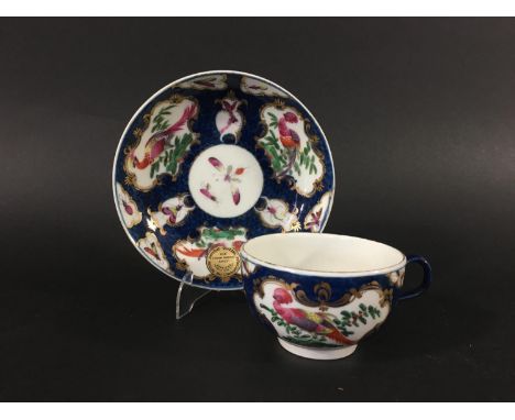 WORCESTER BLUE SCALE TEACUP AND SAUCER circa 1770, gilt mirror shaped cartouches painted with birds and insects, blue fret ma