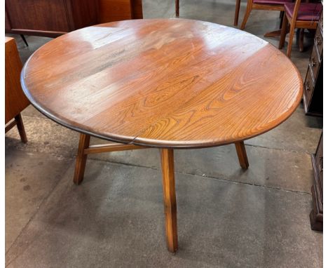 An Ercol Golden Dawn elm dropleaf table 