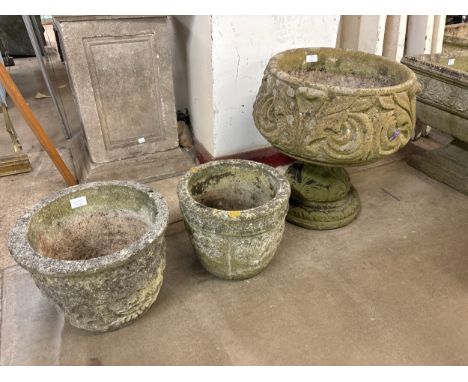 A concrete garden planter on stand and two others 