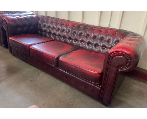 An oxblood faux red leather Chesterfield sofa 