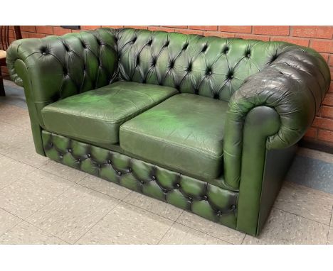 A green leather Chesterfield sofa 