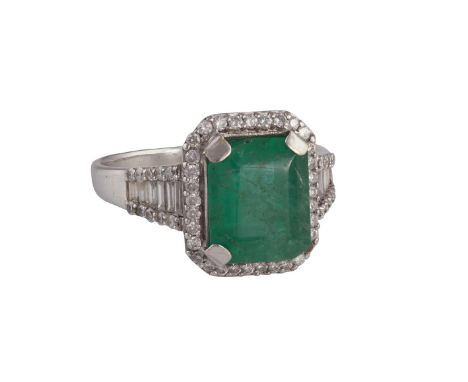 AN EMERALD AND DIAMOND DRESS RINGThe cut-cornered rectangular step-cut emerald weighing approximately 5.53cts within a surrou