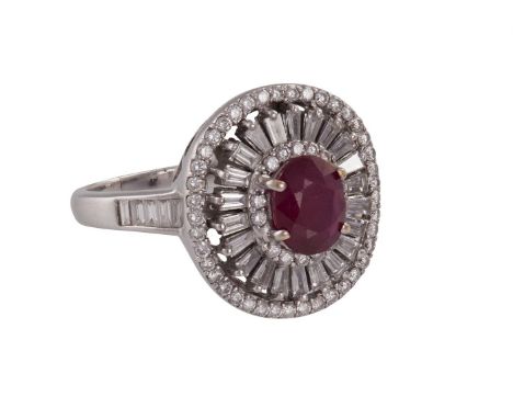 A RUBY AND DIAMOND DRESS RINGThe oval-cut ruby within a surround of brilliant, tapered and baguette-cut diamonds, the whole e