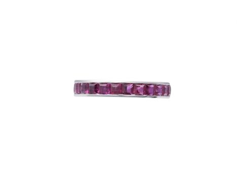 A RUBY ETERNITY RINGComposed of a single row of channel-set calibré-cut rubies, ring size K