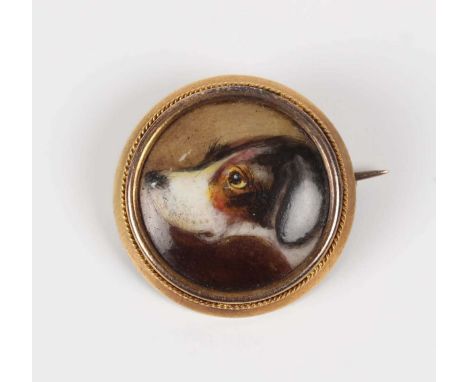 A Victorian gold mounted circular brooch, the enamelled centre painted with the head of a dog, the reverse signed ‘W Essex. 1