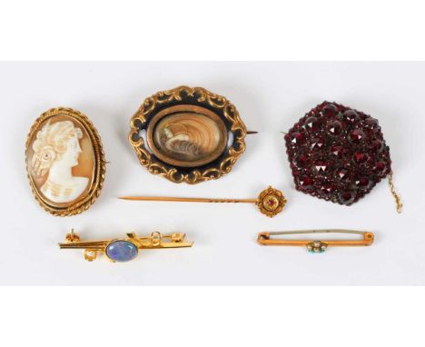 A Bohemian garnet hexagonal brooch, width 3.7cm, a Victorian black enamelled shaped oval mourning brooch, a gilt metal mounte