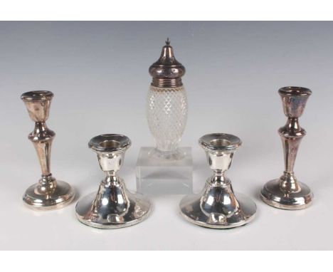 A pair of George V silver stub candlesticks, each urn shaped sconce on a flared circular base, Birmingham 1919 by Henry Cliff