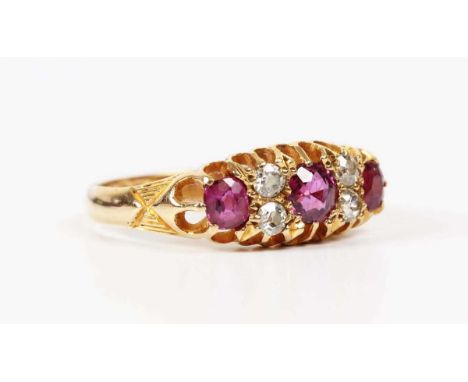 An 18ct gold, ruby and diamond ring, mounted with three cushion shaped rubies alternating with two pairs of old cut diamonds,