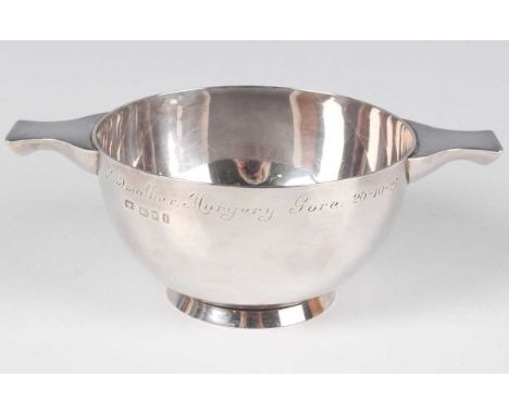 A George V silver quaich with tab handles, inscription engraved, on a circular foot, London 1924 by Garrard &amp; Co Ltd, wei