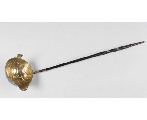 A mid-18th century silver punch ladle, the boat shaped scalloped bowl with gilt interior, fitted with a twisted whalebone han