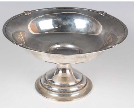 A George V silver tazza, the circular shallow bowl cast with a strapwork and floral rim, on a tapering stem and circular step