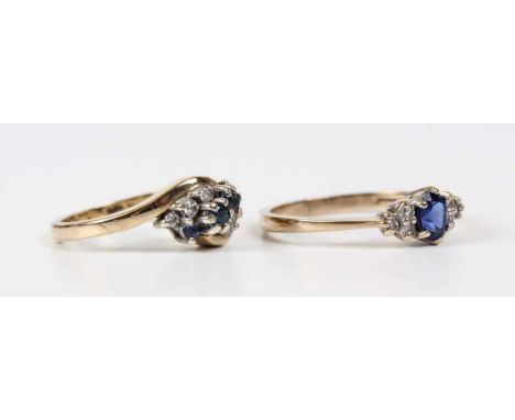 A 9ct gold, sapphire and diamond ring, claw set with an oval cut sapphire between circular cut diamond set three stone sides,
