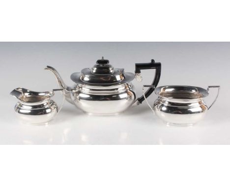 A George V silver three-piece tea set of cushion form, comprising teapot, two-handled sugar bowl and milk jug, Birmingham 193