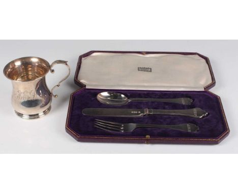 A George V silver baluster christening mug with scroll handle, on a circular foot, initial engraved, London 1928, height 8.8c