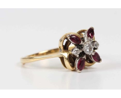 An 18ct gold, diamond and ruby ring of abstract floral form, mounted with three circular cut diamonds and four marquise shape