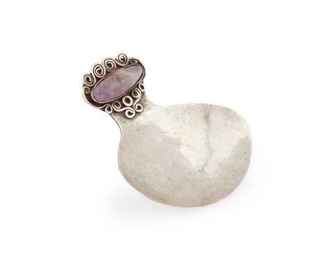 SCOTTISH, MANNER OF MARY THEW CADDY SPOON, CIRCA 1910 white metal set with an oval amethyst, unmarked(6.5cm high)Footnote: No