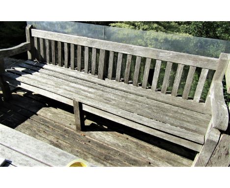 A good quality weathered teak garden bench, 240cm long 